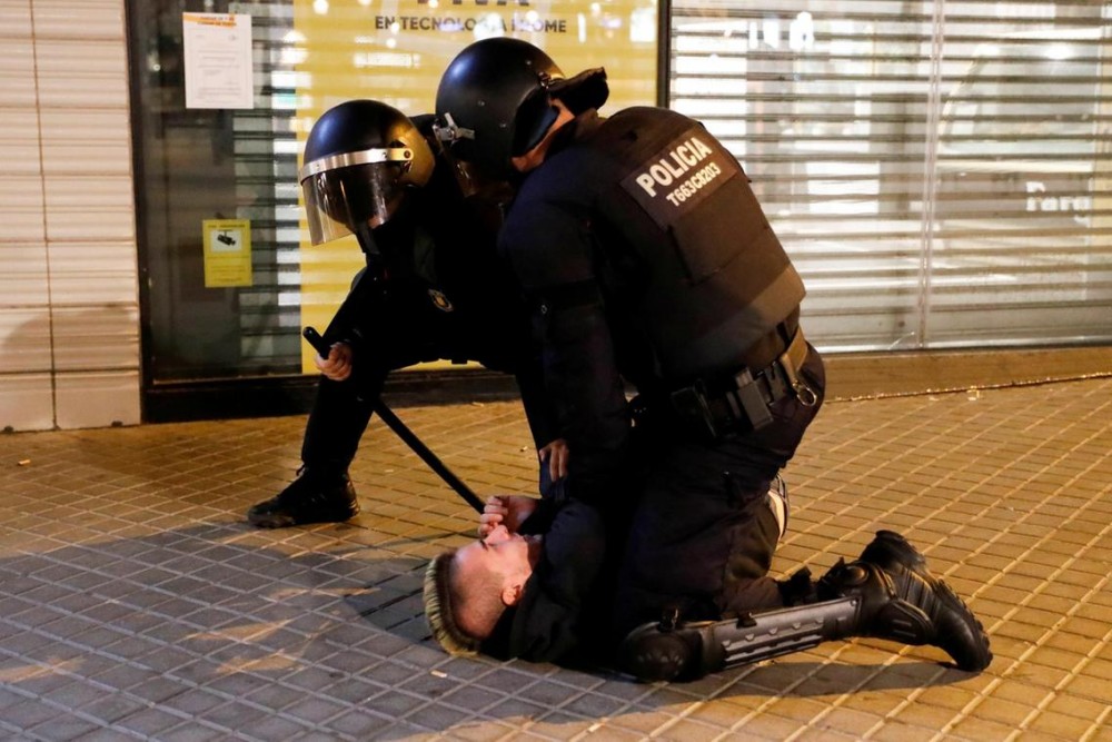 Police officers restrain a person during a protest against the closure of bars and gyms, amidst the coronavirus disease (COVID-19) outbreak, in Barcelona, Spain October 30, 2020. REUTERS/Nacho Doce TPX IMAGES OF THE DAY